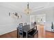 Elegant dining room with wood floors, decorative molding, and a modern light fixture at 405 Branch Forest Way, Stockbridge, GA 30281