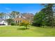 Traditional brick home featuring a large front yard and mature trees at 405 Branch Forest Way, Stockbridge, GA 30281