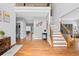 Inviting foyer with hardwood floors, staircase with wood banister, and decorative art at 405 Branch Forest Way, Stockbridge, GA 30281