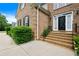 Charming brick home featuring a classic black front door and well-manicured landscaping at 405 Branch Forest Way, Stockbridge, GA 30281
