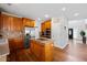 Well-lit kitchen featuring wood cabinets, stainless steel appliances, granite countertops, and a central island at 405 Branch Forest Way, Stockbridge, GA 30281