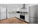 A compact kitchen featuring stainless steel appliances, white cabinets and granite countertops at 405 Branch Forest Way, Stockbridge, GA 30281