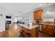 Open concept kitchen boasts an island with bar seating and stainless steel appliances, flowing to the living space at 405 Branch Forest Way, Stockbridge, GA 30281