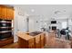 Open-concept kitchen and living room with modern appliances and a cozy fireplace at 405 Branch Forest Way, Stockbridge, GA 30281