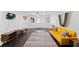 Spacious living room featuring dark wood flooring and a bright yellow sofa at 405 Branch Forest Way, Stockbridge, GA 30281