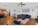 Open-concept living room featuring hardwood floors, stylish decor, and comfortable seating at 405 Branch Forest Way, Stockbridge, GA 30281