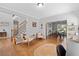 Inviting living room features hardwood floors, staircase, and neutral decor, creating a comfortable space at 405 Branch Forest Way, Stockbridge, GA 30281