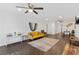 Spacious living room with tiled floors, modern decor, a yellow sofa, and ample seating area at 405 Branch Forest Way, Stockbridge, GA 30281