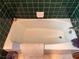 Bathroom featuring green tile walls and a bathtub at 871 Malcom Se St, Conyers, GA 30012