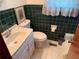 Bathroom featuring green tile walls, a pedestal sink, and a toilet at 871 Malcom Se St, Conyers, GA 30012