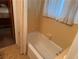 Bathroom featuring yellow tile walls and a bathtub at 871 Malcom Se St, Conyers, GA 30012