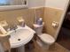 Bathroom featuring yellow tile walls, a pedestal sink, and a toilet at 871 Malcom Se St, Conyers, GA 30012
