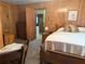 Bedroom with wood paneling and view into the kitchen at 871 Malcom Se St, Conyers, GA 30012