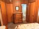 Bedroom featuring paneled walls, two closets, a dresser, and an attached bathroom at 871 Malcom Se St, Conyers, GA 30012