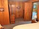 Bedroom featuring paneled walls, a dresser, and an attached bathroom at 871 Malcom Se St, Conyers, GA 30012