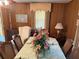 View of dining room, featuring wood paneled walls and floral centerpiece at 871 Malcom Se St, Conyers, GA 30012