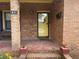 Close-up of the front entryway, showcasing the yellow front door, and brick porch at 871 Malcom Se St, Conyers, GA 30012