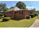 Charming brick house featuring a well-maintained lawn and mature trees at 871 Malcom Se St, Conyers, GA 30012