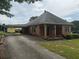 View of the home's exterior, including a covered carport and a long driveway leading to the residence at 871 Malcom Se St, Conyers, GA 30012