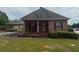 Charming brick home featuring a covered carport and a well-maintained front lawn and flower beds at 871 Malcom Se St, Conyers, GA 30012