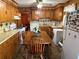 Kitchen featuring wood cabinets, linoleum floors, and a dining table at 871 Malcom Se St, Conyers, GA 30012