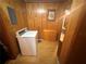 A dedicated laundry room features a washing machine, a wooden cabinet, and wood paneling at 871 Malcom Se St, Conyers, GA 30012