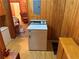 A dedicated laundry room features a washing machine and wood paneling at 871 Malcom Se St, Conyers, GA 30012
