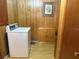 Functional laundry room with a washing machine and wooden cabinets at 871 Malcom Se St, Conyers, GA 30012