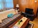 A cozy living room features a plaid couch and wooden coffee table with a television at 871 Malcom Se St, Conyers, GA 30012