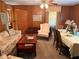 Spacious living room featuring wood paneling, dining table and a floral sofa at 871 Malcom Se St, Conyers, GA 30012