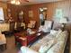 Cozy living room with wood paneled walls, and a view of dining area with furnishings at 871 Malcom Se St, Conyers, GA 30012