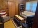A warm living room with wood paneling, a plaid sofa, and vintage coffee table at 871 Malcom Se St, Conyers, GA 30012