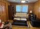 A warm living room with plaid sofa, vintage coffee table, and natural lighting at 871 Malcom Se St, Conyers, GA 30012