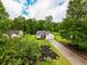 An aerial view of a charming home featuring a well-manicured lawn and a spacious driveway at 1444 Elliotts Lane, Auburn, GA 30011
