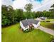Aerial view of home with green lawn, brick accents, and an attached garage at 1444 Elliotts Lane, Auburn, GA 30011