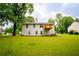 Exterior of home showcases a spacious backyard, deck, and lush green lawn at 1444 Elliotts Lane, Auburn, GA 30011