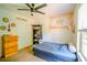 Cozy bedroom featuring a large window, ceiling fan, and cute decorations at 1444 Elliotts Lane, Auburn, GA 30011