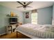 Bedroom featuring a large window, ceiling fan, and fun decor at 1444 Elliotts Lane, Auburn, GA 30011