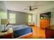 Spacious bedroom with hardwood floors, natural light, ceiling fan, and ample closet space at 1444 Elliotts Lane, Auburn, GA 30011