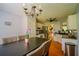Dining room featuring a modern table and chairs, chandelier, and direct access to the kitchen at 1444 Elliotts Lane, Auburn, GA 30011