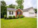 Charming single-story home with red brick accents, white siding, well-maintained landscaping, and attached garage at 1444 Elliotts Lane, Auburn, GA 30011