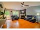 Bright living room with hardwood floors, fireplace, ceiling fan, neutral color scheme, and plenty of seating at 1444 Elliotts Lane, Auburn, GA 30011