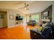 Bright living room with hardwood floors, fireplace, ceiling fan, neutral color scheme, and plenty of seating at 1444 Elliotts Lane, Auburn, GA 30011