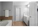 The main bathroom features a garden tub, a separate shower, a white vanity and a tiled floor at 1630 Marsanne Nw Ter # 27, Kennesaw, GA 30152