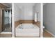 The main bathroom features a garden tub, a separate shower and tiled floors at 1630 Marsanne Nw Ter # 27, Kennesaw, GA 30152