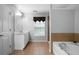 The main bathroom features a garden tub, a separate shower, double vanity, and tiled floors at 1630 Marsanne Nw Ter # 27, Kennesaw, GA 30152