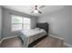 The guest bedroom has wood-look flooring, a window and a ceiling fan at 1630 Marsanne Nw Ter # 27, Kennesaw, GA 30152