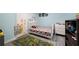 Well-lit bedroom features a cozy bed with superhero bedding and playful road-themed rug at 1630 Marsanne Nw Ter # 27, Kennesaw, GA 30152