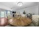 Dining area with hardwood floors, a modern chandelier, and views into the living room at 1630 Marsanne Nw Ter # 27, Kennesaw, GA 30152
