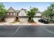View of townhomes featuring landscaped lawns and two-car garages, complemented by a well-maintained street at 1630 Marsanne Nw Ter # 27, Kennesaw, GA 30152